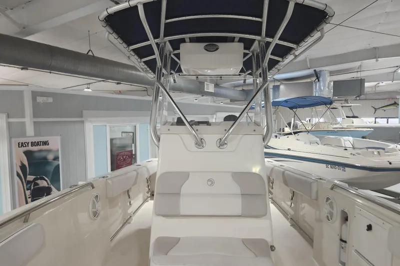 Slide: The Image of 2012 Edgewater 228CC boat interior with seating, storage, and safety equipment. - 16