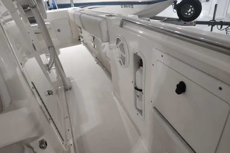 Slide: The Image of 2012 Edgewater 228CC boat interior with seating and speaker, showroom display. - 17