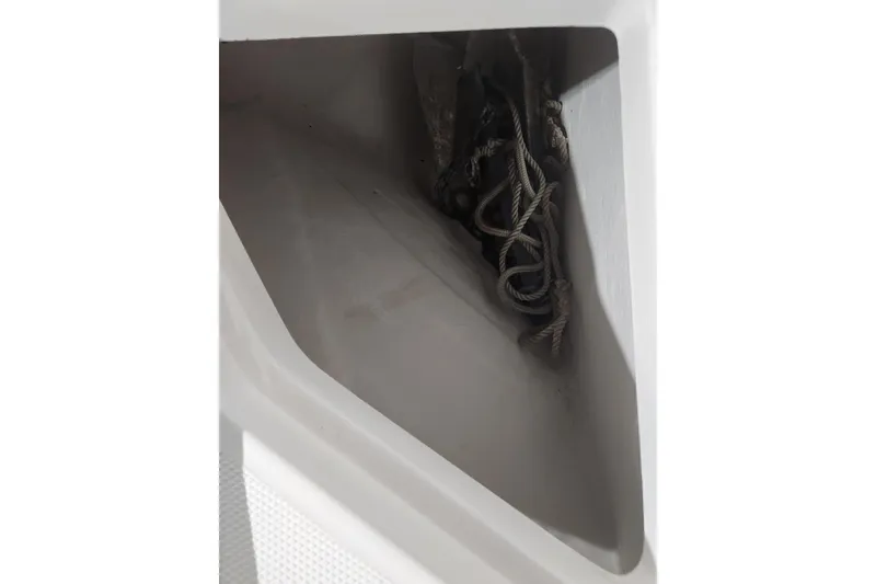Slide: The Image of 2012 Edgewater 228CC boat sink with open lid, showcasing interior and drain. - 21