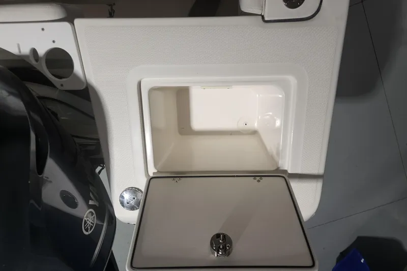 Slide: The Image of Interior of 2012 Edgewater 228CC boat showing seating and storage compartment. - 23