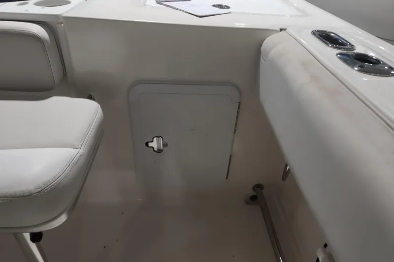 Slide: The Image of Open hatch on 2012 Edgewater 228CC boat, revealing interior compartment. - 24