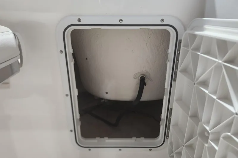 Slide: The Image of Interior view of a 2012 Edgewater 228CC boat, featuring seating and storage compartments. - 25