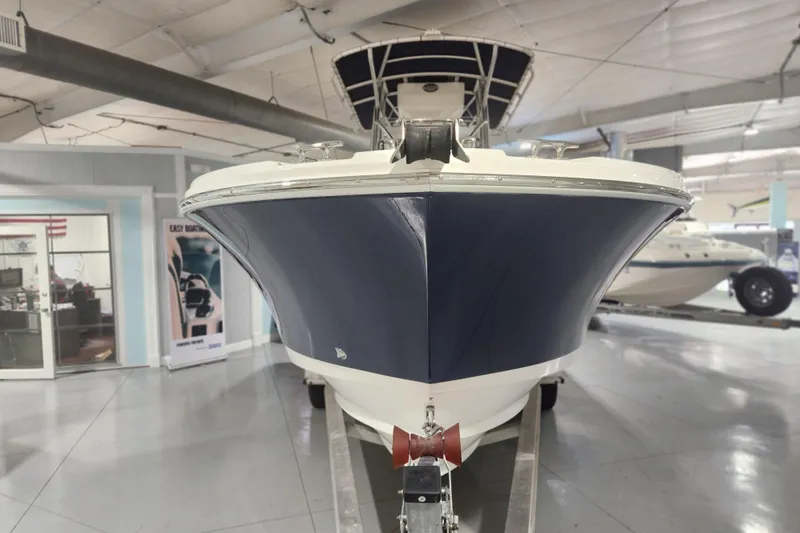 Slide: The Image of 2012 Edgewater 228CC boat with logo and SPI emblem in a showroom. - 5