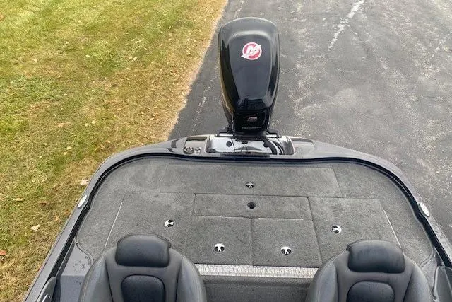 Slide: The Image of 2013 Ranger Z118 boat with Mercury engine, viewed from above on a paved surface. - 5