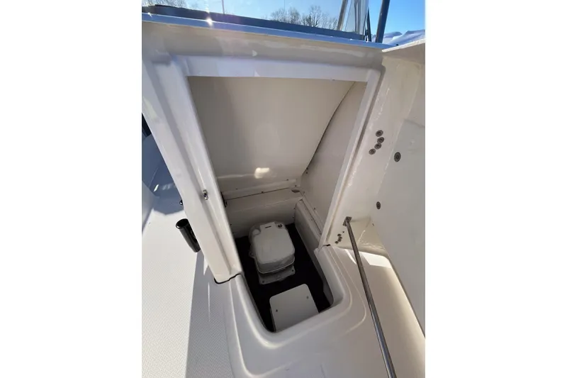 Slide: The Image of 2026 Robalo R180 Center Console storage compartment, open view with interior details. - 11