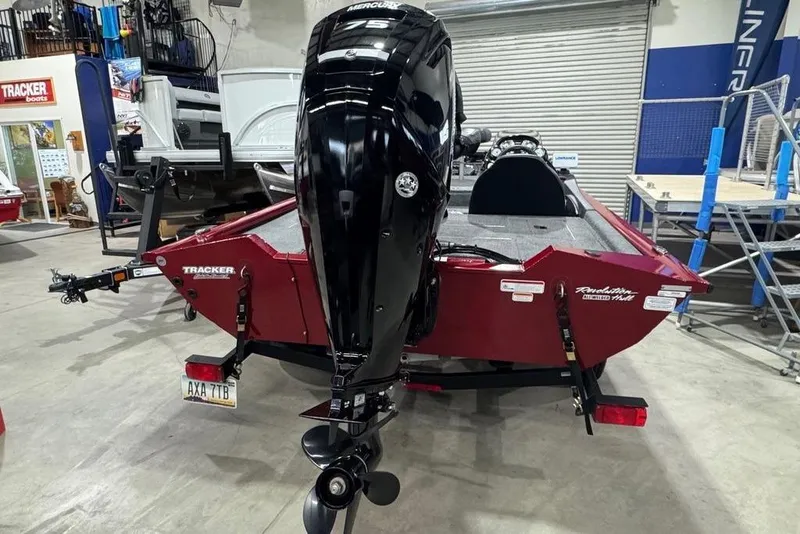 Slide: The Image of 2021 Tracker Pro Team 175 TXW boat with Mercury outboard motor in a showroom. - 17