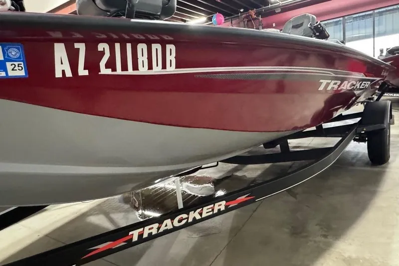 Slide: The Image of 2021 Tracker Pro Team 175 TXW boat in showroom, red and gray design. - 26