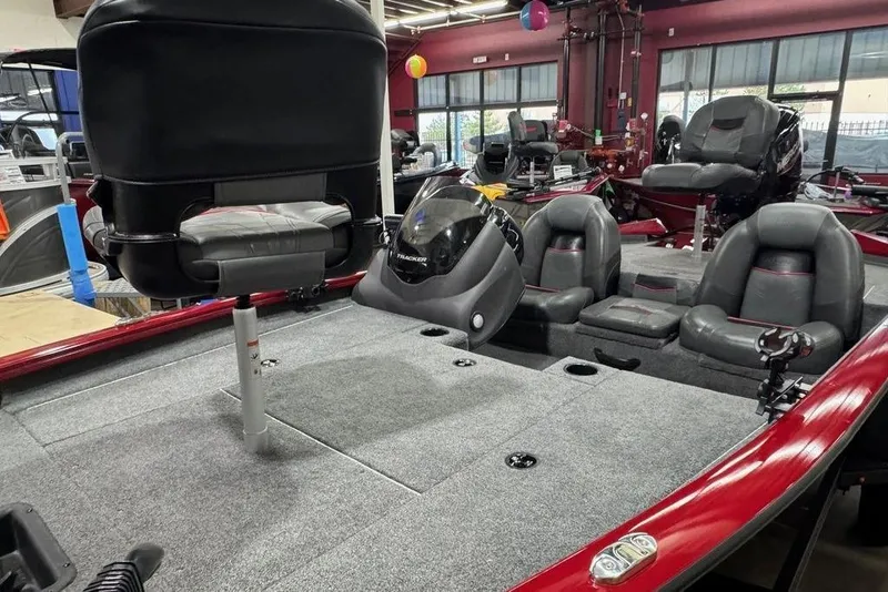 Slide: The Image of 2021 Tracker Pro Team 175 TXW boat interior with seating and dashboard in showroom. - 27