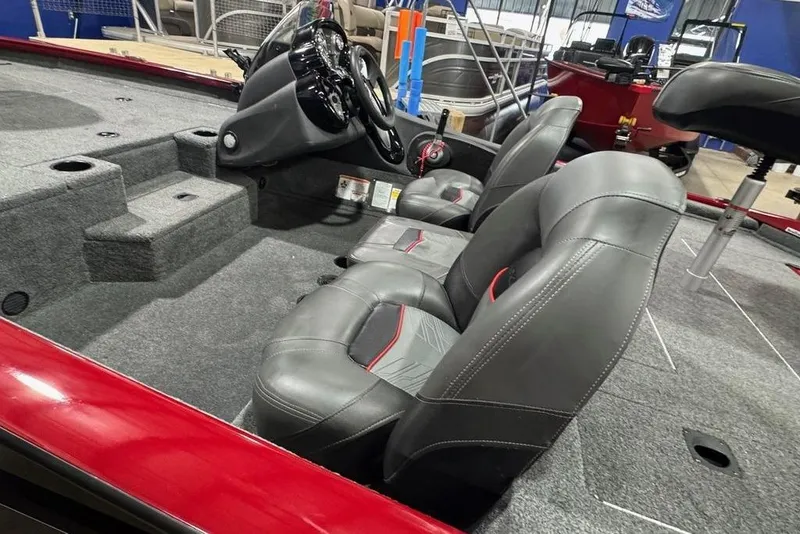 Slide: The Image of 2021 Tracker Pro Team 175 TXW boat interior with gray seats and steering console. - 28