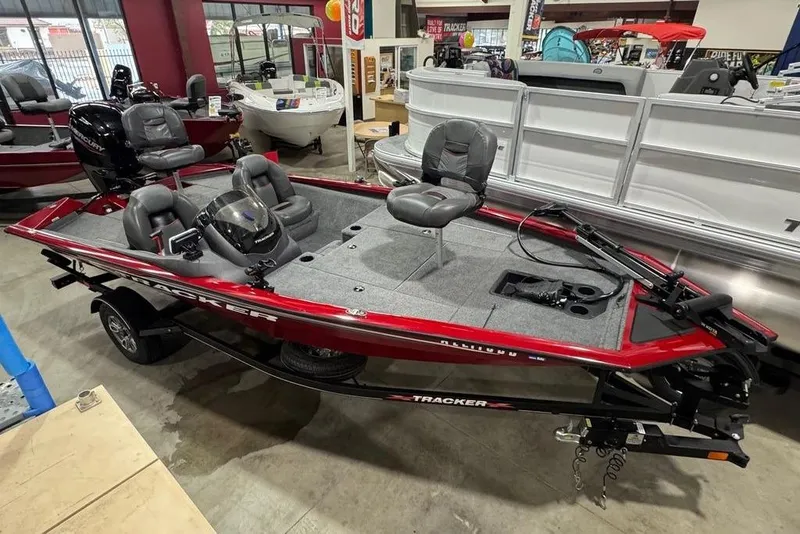 Slide: The Image of 2021 Tracker Pro Team 175 TXW fishing boat in showroom, red and gray design. - 3
