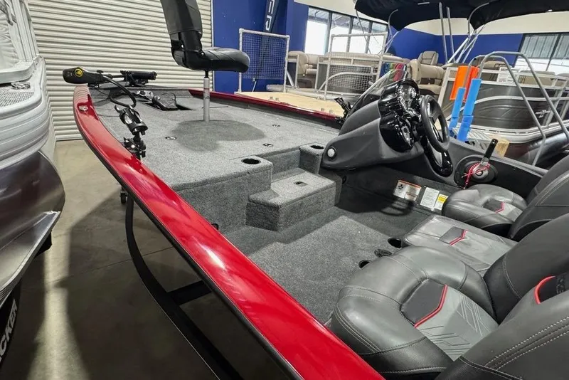 Slide: The Image of 2021 Tracker Pro Team 175 TXW fishing boat interior with red trim and seating. - 31