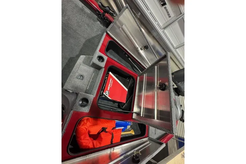 Slide: The Image of 2021 Tracker Pro Team 175 TXW storage compartments with safety gear and manuals. - 37