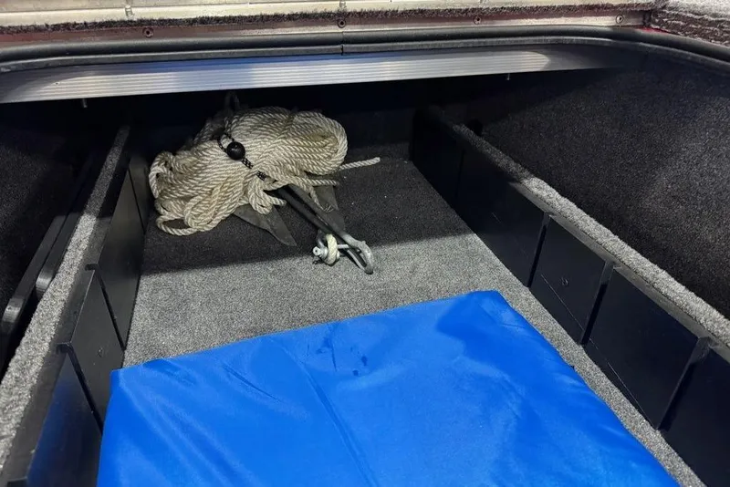 Slide: The Image of Storage compartment of 2021 Tracker Pro Team 175 TXW boat with rope and anchor. - 39