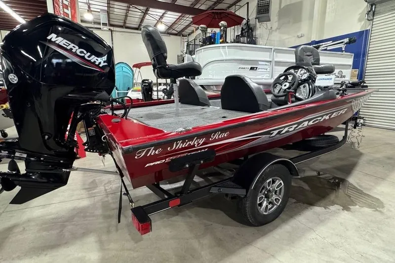 Slide: The Image of 2021 Tracker Pro Team 175 TXW boat in a showroom with Mercury engine. - 4