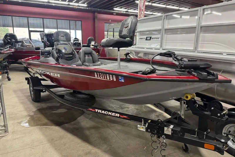 Slide: The Image of 2021 Tracker Pro Team 175 TXW boat displayed in showroom, red and gray color scheme. - 47
