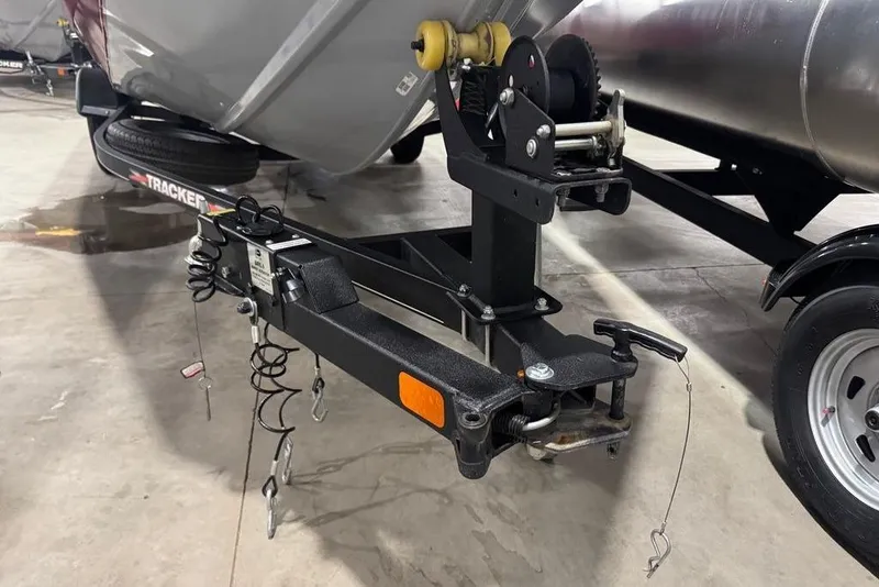 Slide: The Image of Trailer hitch of a 2021 Tracker Pro Team 175 TXW boat in a garage setting. - 6