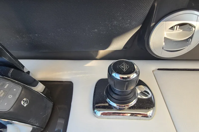 Slide: The Image of Control panel of a 2014 Sea Ray 350 SLX boat, featuring joystick and controls. - 10