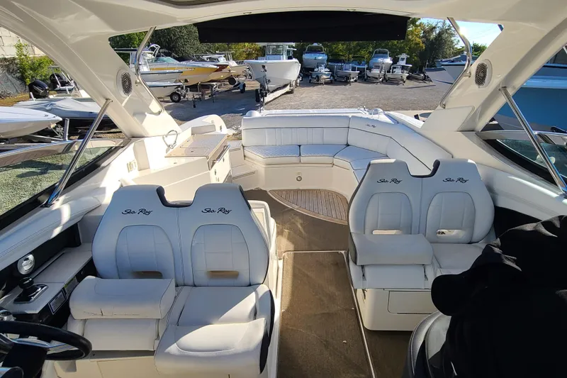 Slide: The Image of 2014 Sea Ray 350 SLX boat interior with white seating and spacious layout. - 14