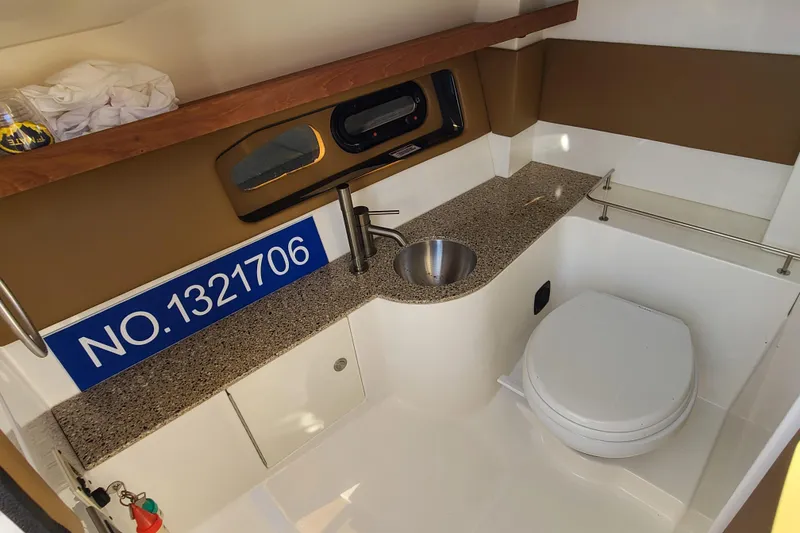 Slide: The Image of Interior of 2014 Sea Ray 350 SLX boat bathroom with sink and toilet. - 17