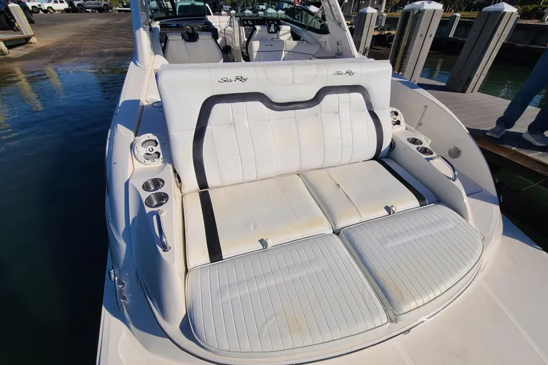 Slide: The Image of 2014 Sea Ray 350 SLX boat with white seating and cup holders at the dock. - 25