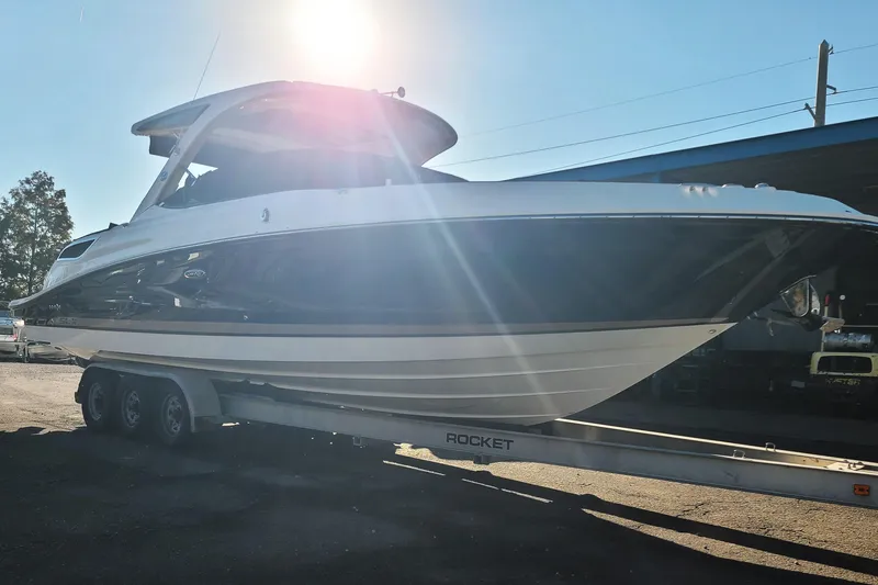 Slide: The Image of 2014 Sea Ray 350 SLX boat on trailer under bright sunlight. - 26