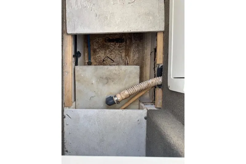 Slide: The Image of 2014 Sea Ray SLX 350 interior compartment with exposed pipes and wiring. - 31