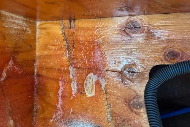 Slide: The Image of Wooden interior detail of a 2014 Sea Ray SLX 350 boat with visible wear and wiring. - 35