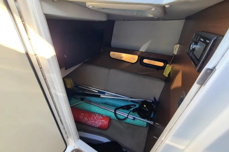 Slide: The Image of Interior cabin of 2014 Sea Ray 350 SLX with storage items and control panel. - 4