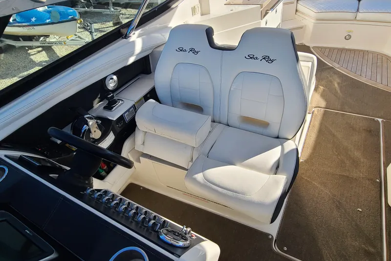 Slide: The Image of Interior of 2014 Sea Ray 350 SLX boat with white leather seats and control panel. - 7