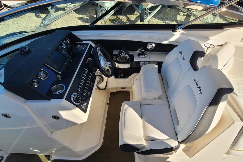 Slide: The Image of 2014 Sea Ray 350 SLX boat cockpit with steering wheel and dual seats. - 8