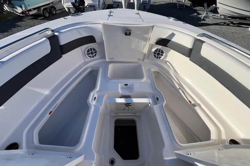 Slide: The Image of 2026 Robalo R257 Dual Console boat interior with open storage compartments. - 13
