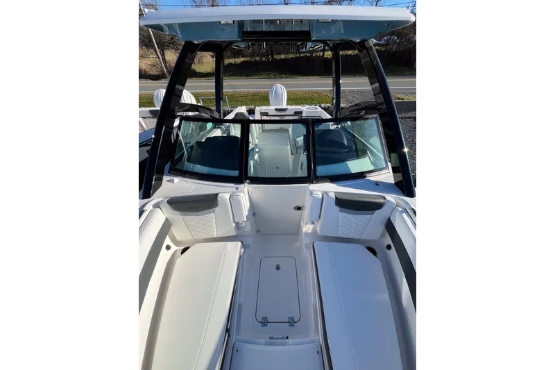 Slide: The Image of 2026 Robalo R257 Dual Console boat interior with seating and windshield. - 16