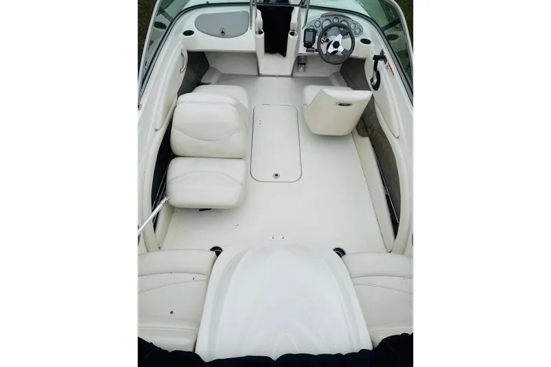 Slide: The Image of 2008 Maxum 1800 MX boat interior with white seating and steering console. - 4