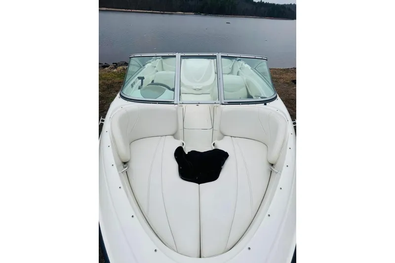 Slide: The Image of 2008 Maxum 1800 MX boat with white interior, docked by a serene lake. - 5