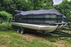 Slide: The Image of 2026 Bentley Pontoons Legacy 223 Navigator, green exterior, parked on gravel lot. - 1