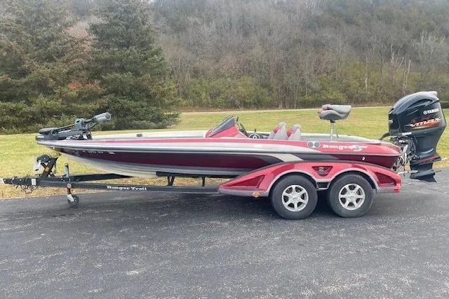 The Image of 2009 Ranger Z20 Comanche bass boat on trailer, parked outdoors. - 1