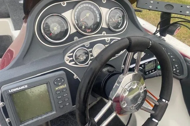 Slide: The Image of Dashboard of a 2009 Ranger Z20 Comanche boat with steering wheel and navigation system. - 3