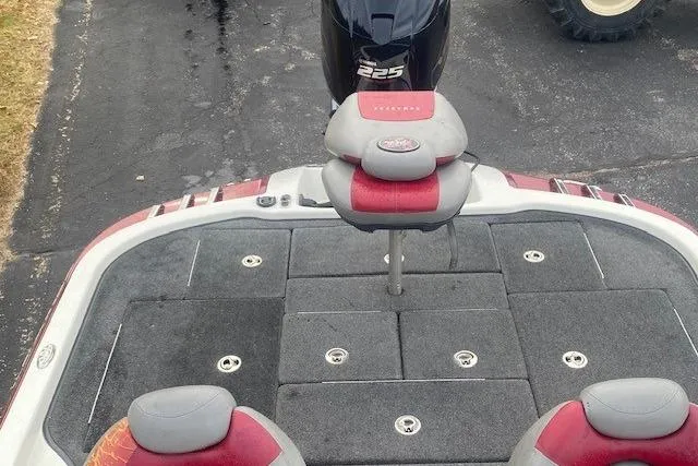 Slide: The Image of 2009 Ranger Z20 Comanche boat deck with seating and motor, featuring red and gray accents. - 4