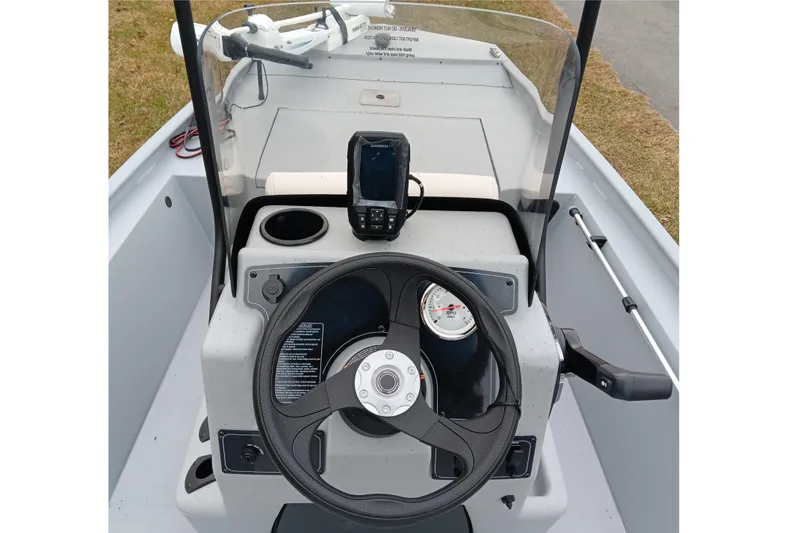 Slide: The Image of 2026 Tracker Bass Tracker Classic CC boat dashboard with steering wheel and navigation system. - 12