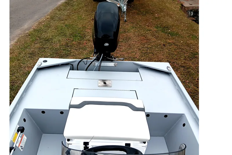 Slide: The Image of 2026 Tracker Bass Tracker Classic CC boat with motor, parked on grass. - 14