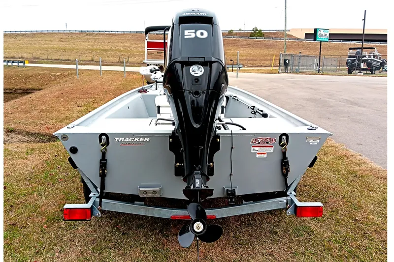 Slide: The Image of 2026 Tracker Bass Tracker Classic CC boat with Mercury 50 engine, parked on grass. - 3