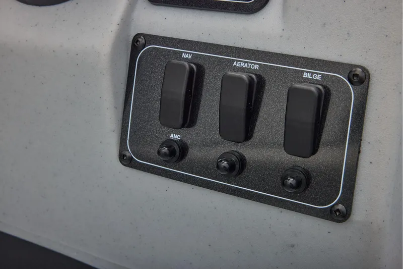 Slide: The Image of Manufacturer Provided Image: Control panel of 2026 Tracker Bass Tracker Classic CC boat with switches for navigation, aerator, and bilge. - 47