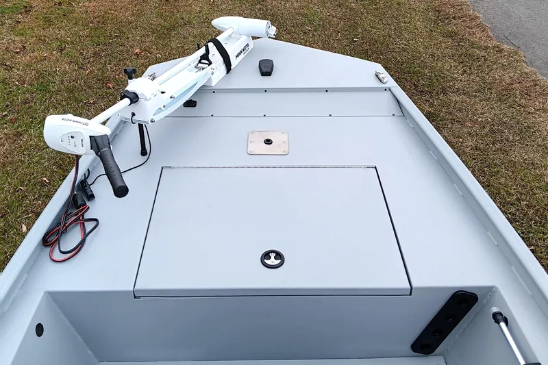 Slide: The Image of 2026 Tracker Bass Tracker Classic CC boat deck with trolling motor, parked on grass. - 8