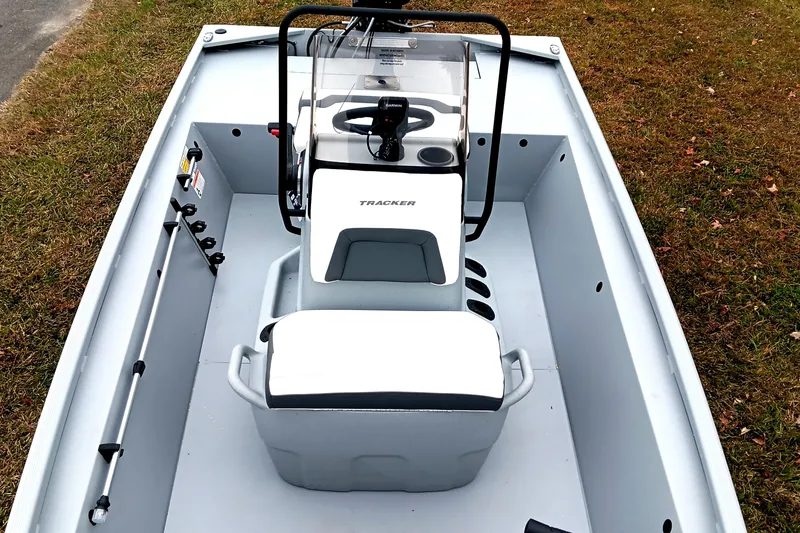 Slide: The Image of 2026 Tracker Bass Tracker Classic CC boat interior with steering console and seating. - 9
