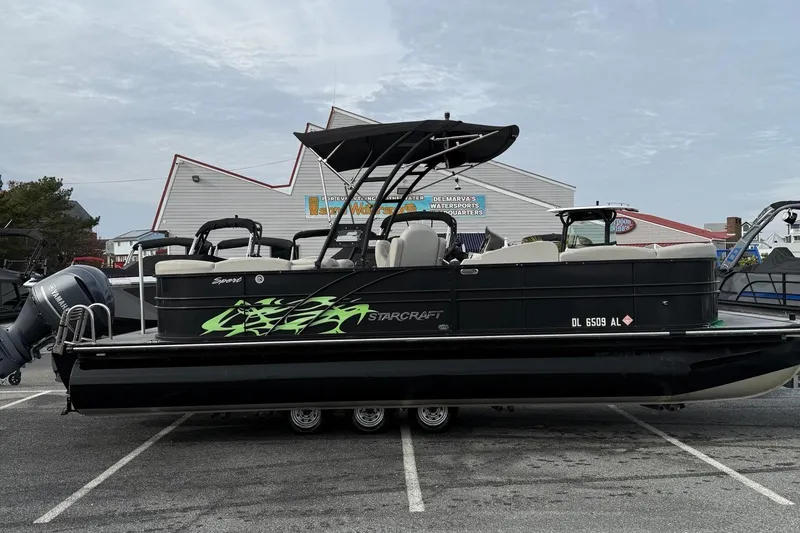 The Image of 2018 Starcraft SLS 5 pontoon boat with Yamaha outboard motor in parking lot. - 1