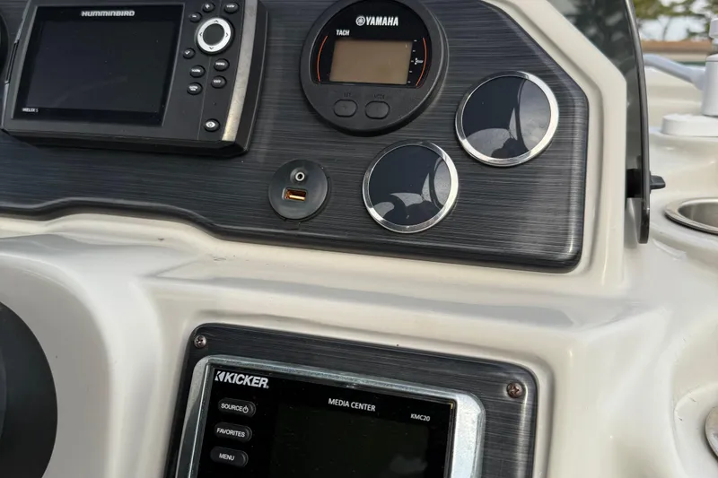 Slide: The Image of 2018 Starcraft SLS 5 boat dashboard with Yamaha tachometer and Kicker media center. - 14