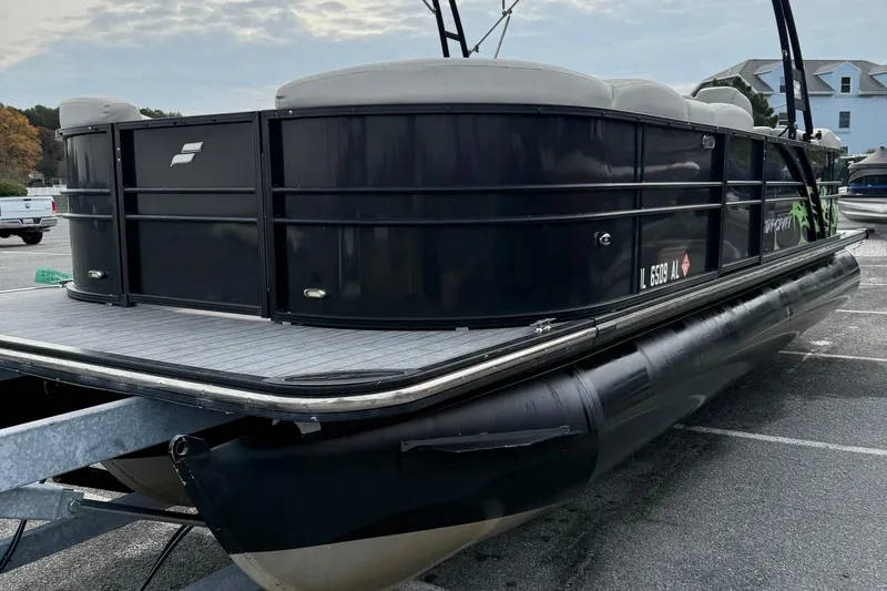 Slide: The Image of 2018 Starcraft SLS 5 pontoon boat in a parking lot, side view. - 4