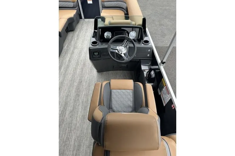 Slide: The Image of 2026 Bennington S Quad Bench 22 SSR boat interior with steering console and seating. - 14