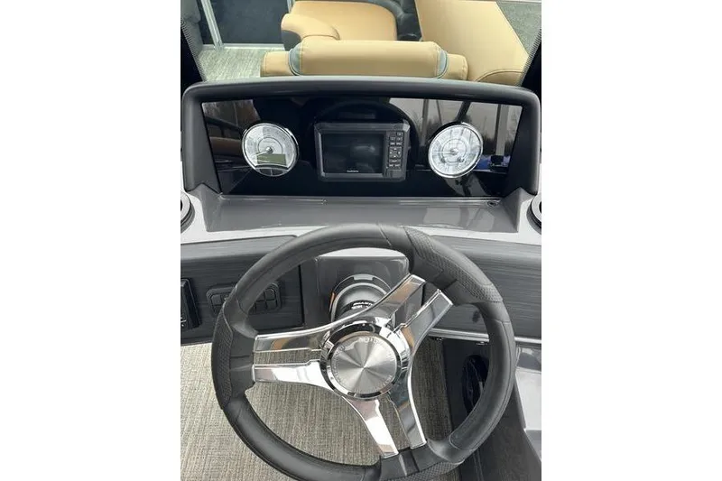 Slide: The Image of Steering console of 2026 Bennington S Quad Bench 22 SSR with modern gauges and controls. - 16