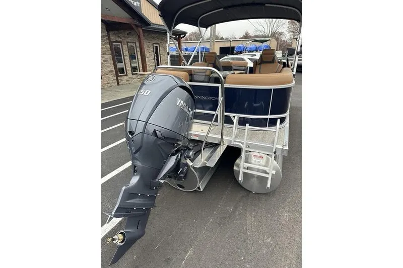 Slide: The Image of 2026 Bennington S Quad Bench 22 SSR pontoon boat with Yamaha outboard motor. - 5